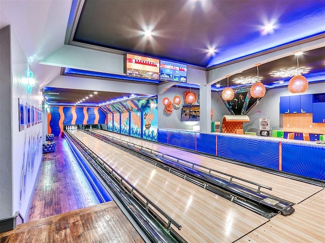 game room featuring hardwood / wood-style floors and a bowling alley