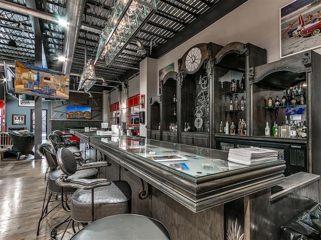 bar featuring hardwood / wood-style flooring