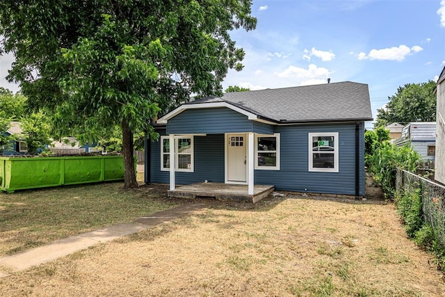 bungalow-style house featuring a front lawn