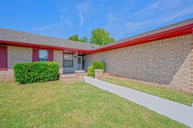 entrance to property with a yard