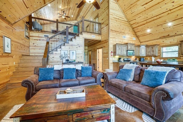 living room featuring high vaulted ceiling, wood ceiling, and wood walls