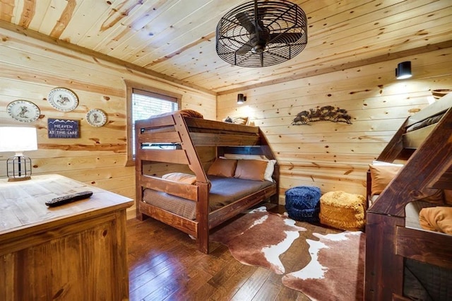 bedroom with wooden walls, dark wood-type flooring, and wooden ceiling