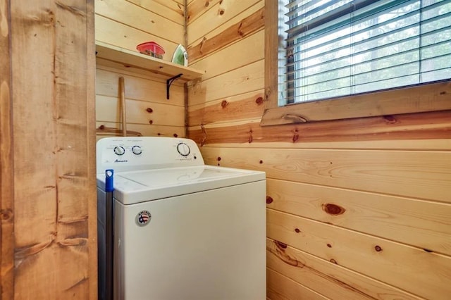 washroom with washer / clothes dryer and wooden walls