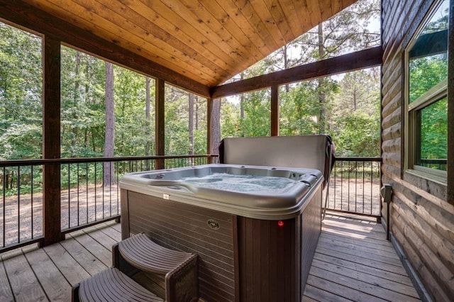 sunroom featuring lofted ceiling, wood ceiling, and a hot tub