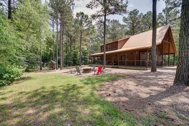 view of yard with a fire pit