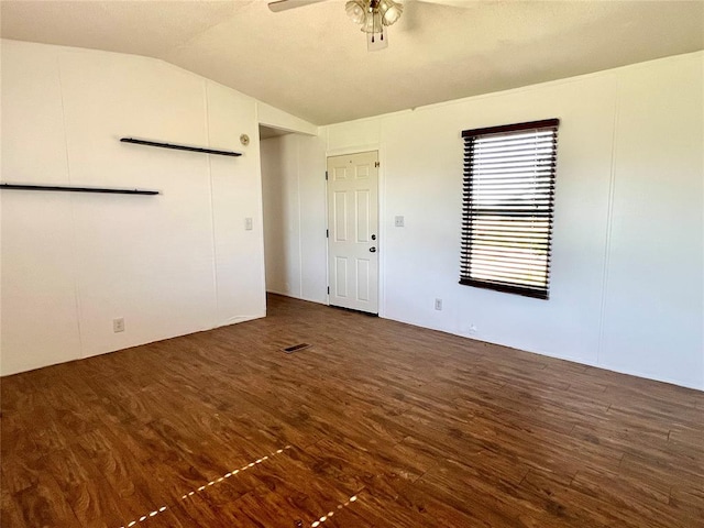 unfurnished room with ceiling fan, dark wood-type flooring, and lofted ceiling