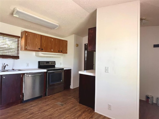 kitchen with electric range, dishwasher, sink, dark wood-type flooring, and black refrigerator