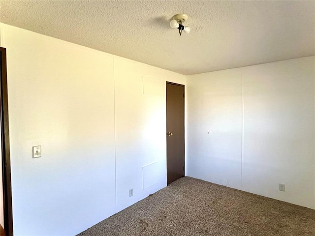 unfurnished bedroom with carpet flooring, a closet, and a textured ceiling