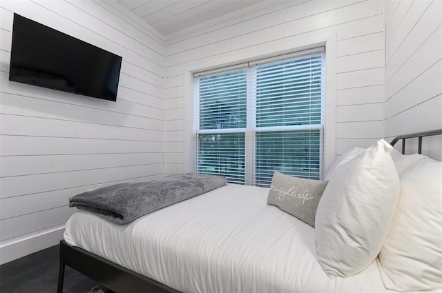 bedroom featuring wood walls