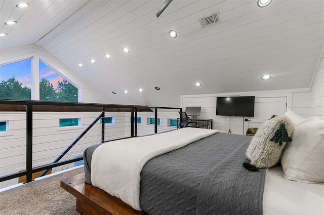 bedroom with carpet flooring and lofted ceiling