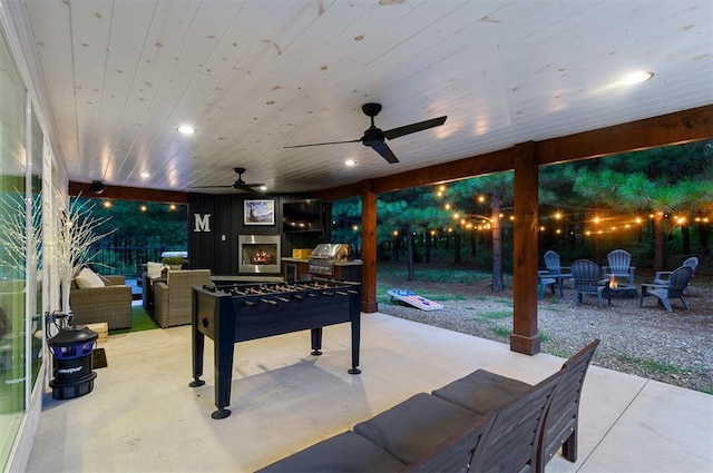 view of patio / terrace featuring an outdoor living space with a fireplace and ceiling fan