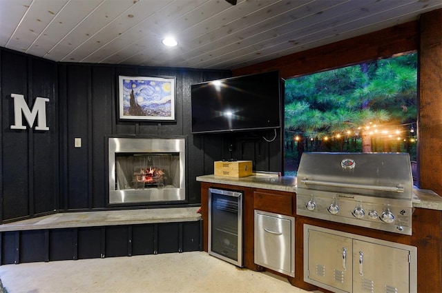 view of patio with wine cooler, area for grilling, and exterior kitchen