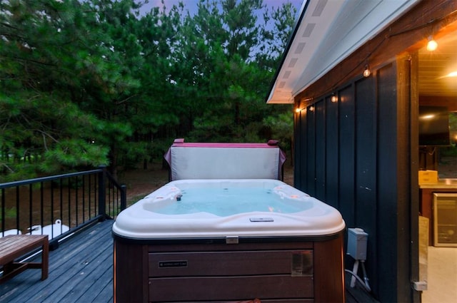 deck at dusk with a hot tub