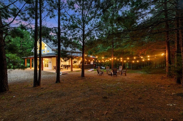 yard at dusk with a patio area