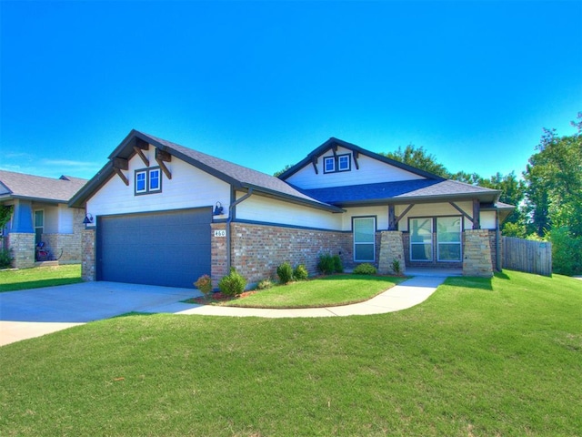 view of front of home featuring a garage and a front lawn