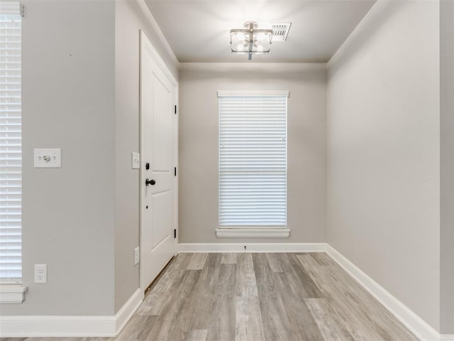 foyer entrance with light hardwood / wood-style floors