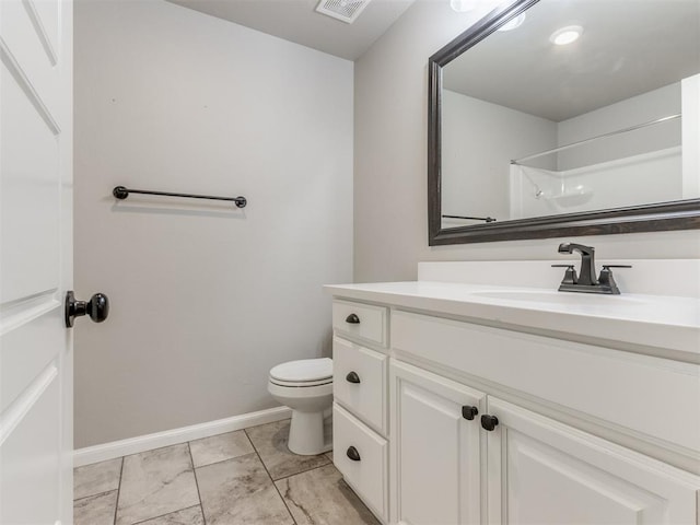 bathroom featuring vanity, toilet, and walk in shower