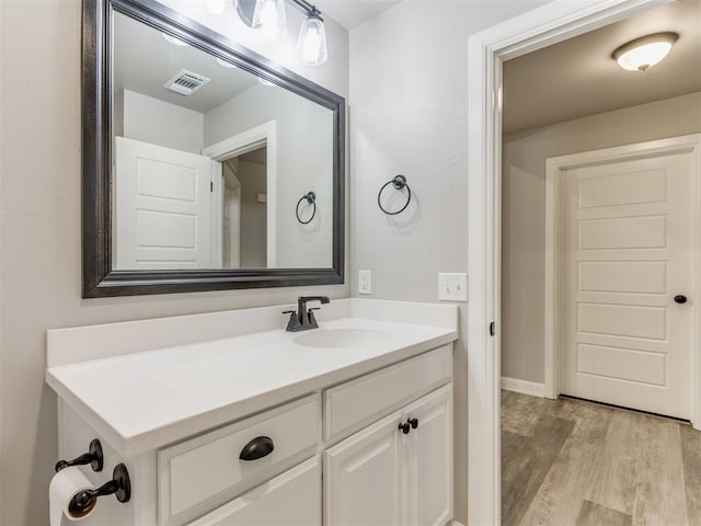 bathroom with vanity and hardwood / wood-style flooring