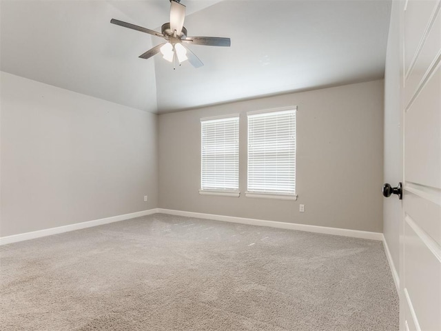 spare room with ceiling fan, carpet, and vaulted ceiling