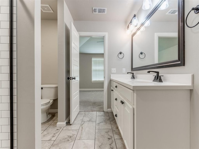 bathroom with vanity and toilet