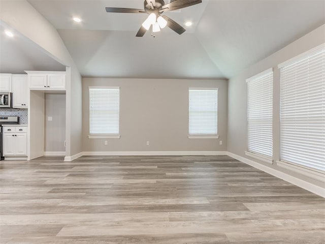 unfurnished living room featuring ceiling fan, plenty of natural light, high vaulted ceiling, and light hardwood / wood-style flooring