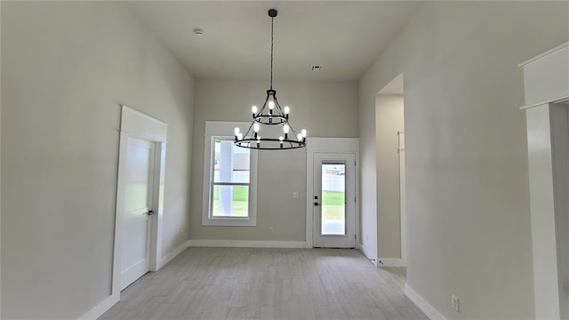 entryway featuring light hardwood / wood-style flooring and a notable chandelier