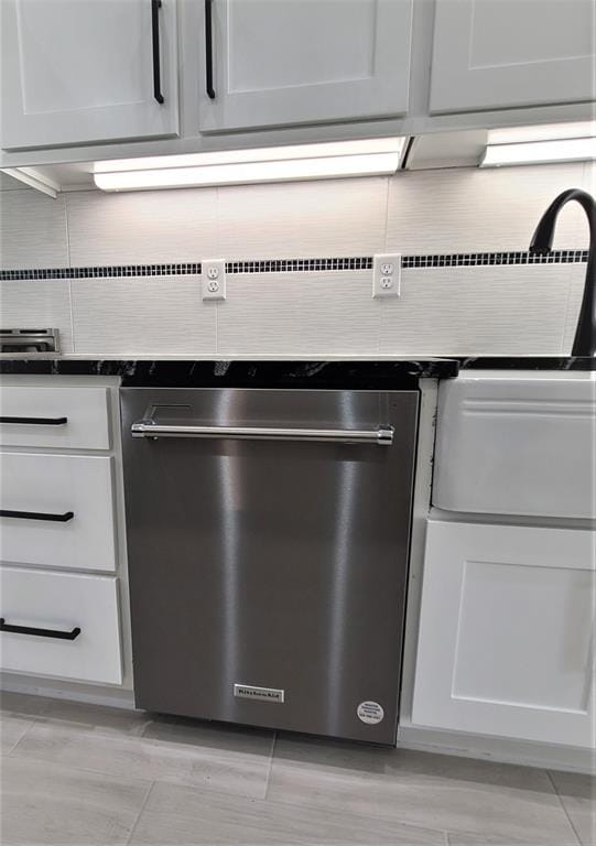 room details with dishwasher, white cabinets, and light hardwood / wood-style flooring