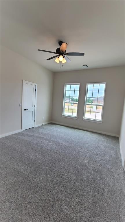 empty room featuring carpet and ceiling fan