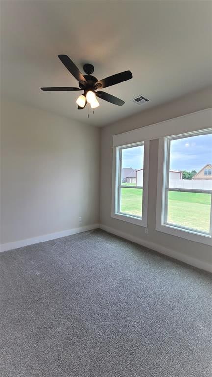 spare room featuring ceiling fan and carpet floors