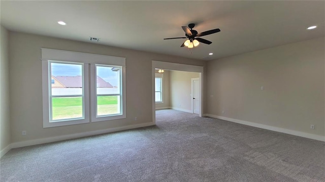 carpeted empty room featuring ceiling fan