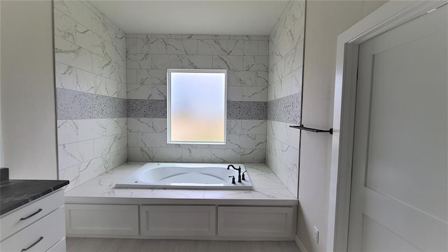 bathroom featuring a tub to relax in and vanity