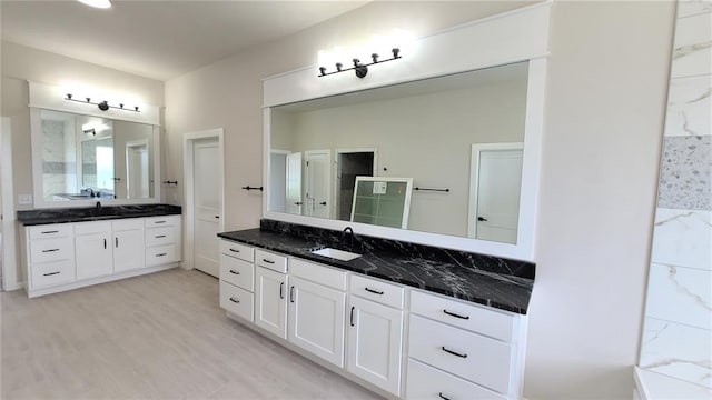 bathroom featuring wood-type flooring and vanity