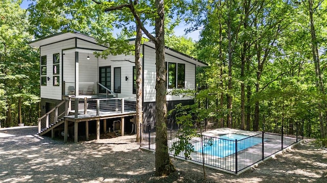 rear view of house with a swimming pool side deck