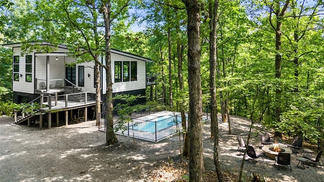 view of swimming pool with an outdoor fire pit and a wooden deck