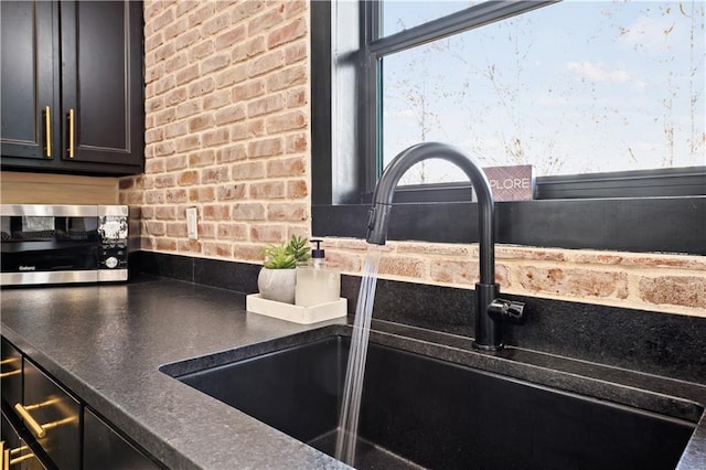 kitchen with sink and brick wall