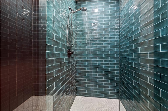 bathroom with tiled shower