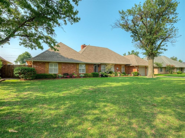 ranch-style house featuring a front yard and a garage