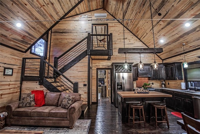 21 Mayflower Cir, Broken Bow, OK 74728 - living room featuring wood walls, wood ceiling, high vaulted ceiling, dark wood-type flooring, and stairs