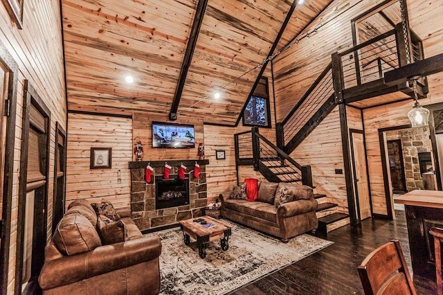 21 Mayflower Cir, Broken Bow, OK 74728 - living room with wooden ceiling with exposed beams, wood walls, wood finished floors, a stone fireplace, and high vaulted ceiling