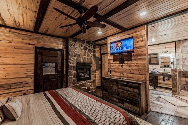 21 Mayflower Cir, Broken Bow, OK 74728 - bedroom featuring wood ceiling with exposed beams, wooden walls, an outdoor stone fireplace, wood-type flooring, and recessed lighting
