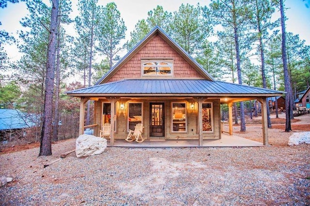 21 Mayflower Cir, Broken Bow, OK 74728 - view of front of house featuring a porch and metal roof