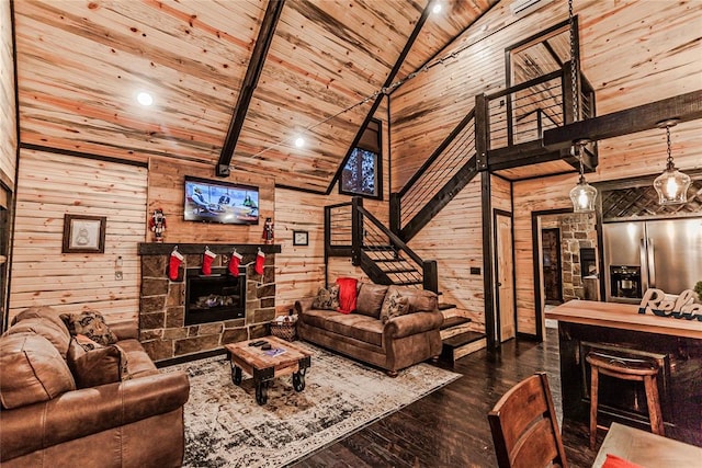 21 Mayflower Cir, Broken Bow, OK 74728 - living area featuring wood walls, dark wood finished floors, wooden ceiling with exposed beams, a stone fireplace, and high vaulted ceiling