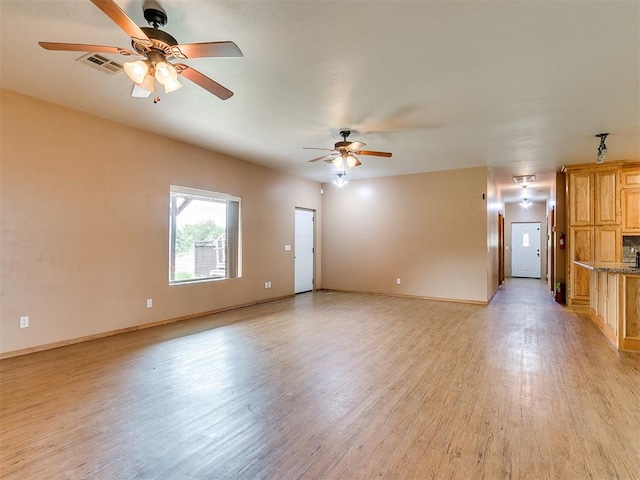 unfurnished living room with ceiling fan and light wood-type flooring