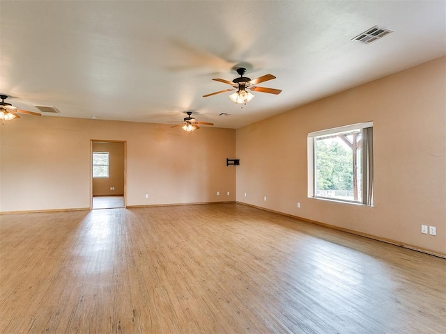 empty room with light hardwood / wood-style flooring