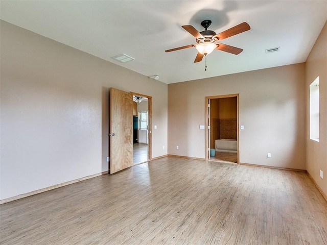 spare room with ceiling fan, light hardwood / wood-style flooring, and plenty of natural light