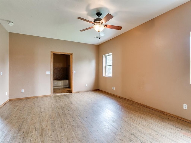 spare room featuring ceiling fan and light hardwood / wood-style flooring