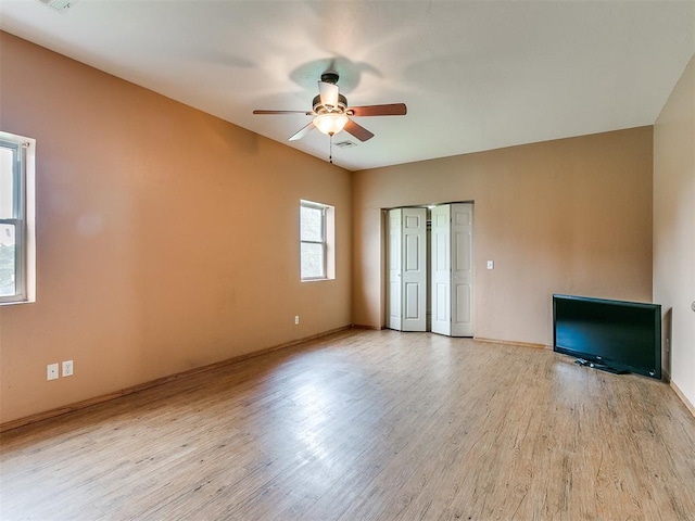 unfurnished living room with light hardwood / wood-style flooring and ceiling fan