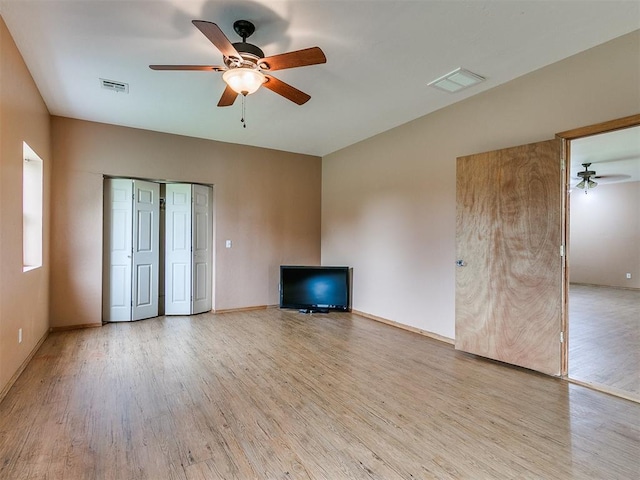 unfurnished living room with ceiling fan and light hardwood / wood-style flooring