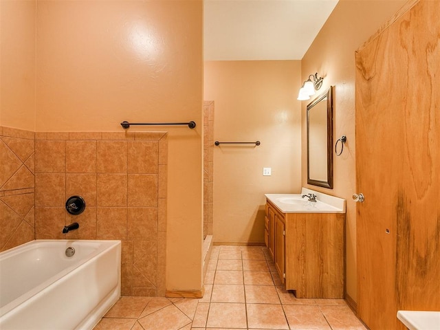 bathroom featuring tile patterned flooring, vanity, and a washtub