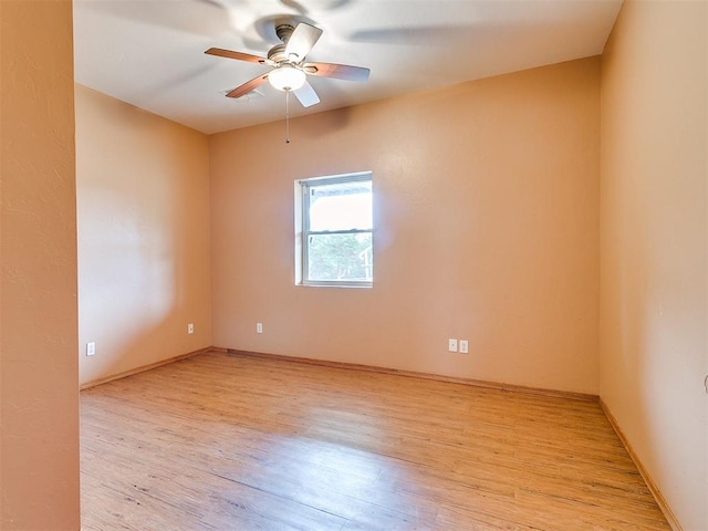 spare room featuring light wood-type flooring and ceiling fan